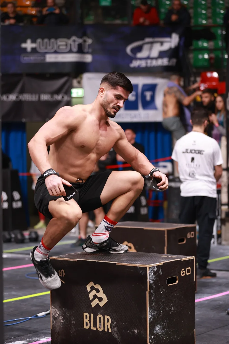 An athlete competing at a CrossFit event, with green face search brackets